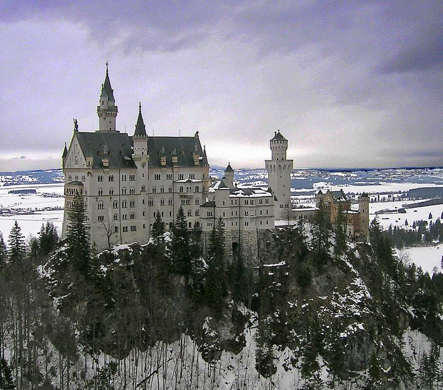 Winter view of Neuschwanstein Castle as seen from the Marienbruecke (Mary's Bridge). This castle is the best known of the three royal palaces built by King Ludwig II of Bavaria. The design and decoration of the castle pay homage to various medieval legends.